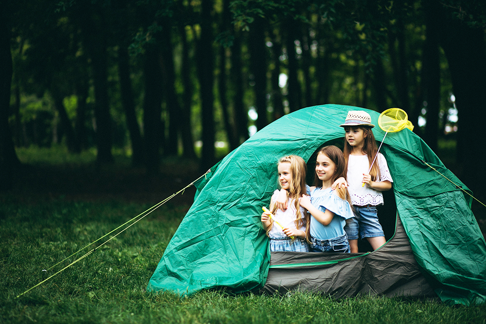 Group of girls camping in forest